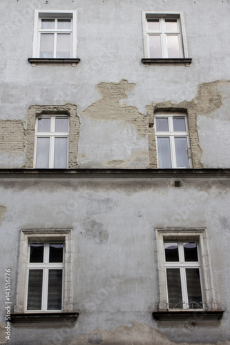 Six windows on the facade of the ragged old house