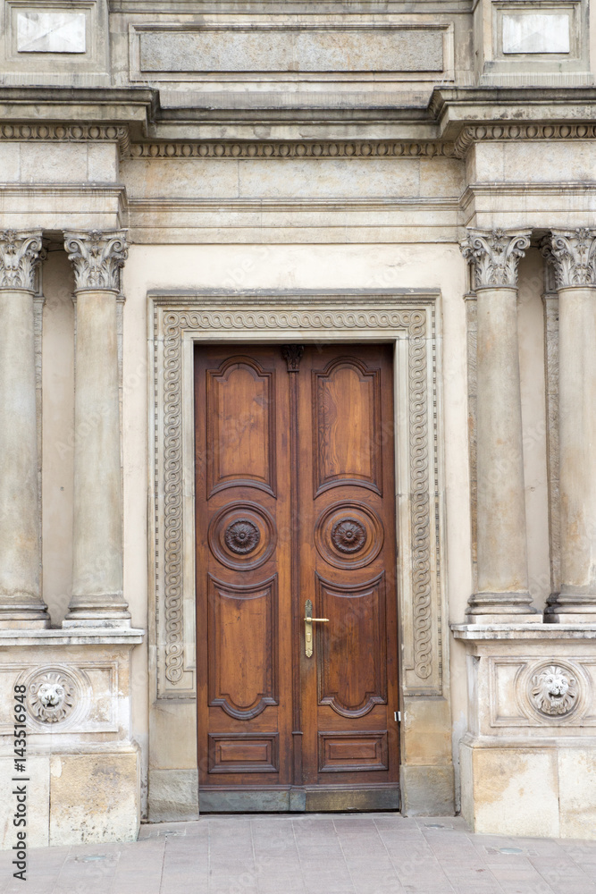 Fototapeta premium The vintage brown wooden front door of an old house