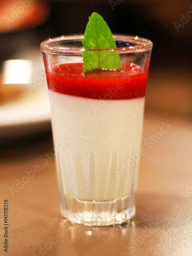 delicious dessert panna cotta in a glass and fresh strawberries