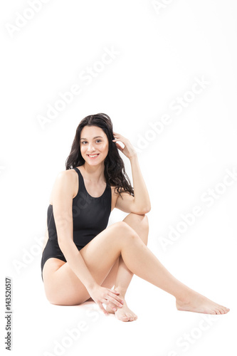 one young woman, sitting swimsuit