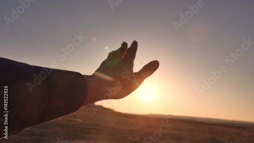 travel. man looks at the sun through her hand lifestyle travel
