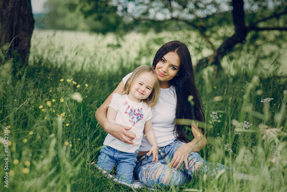 child near tree with mom child near tree with mom