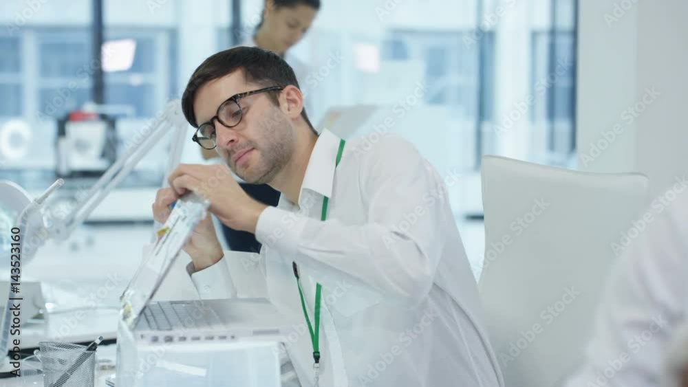 Electronics engineers working in lab building & testing electronic devices Electronics engineers working in lab building & testing electronic devices