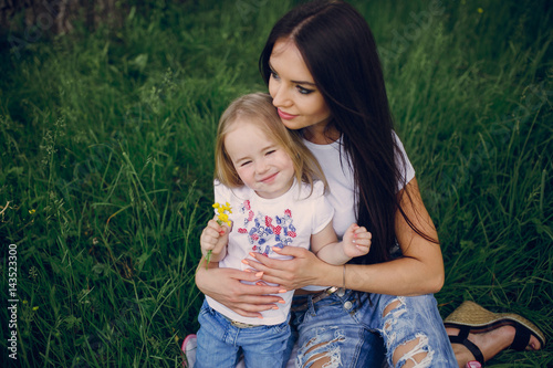 child near tree with mom