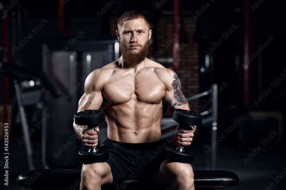 Young athlete doing exercises in the gym.