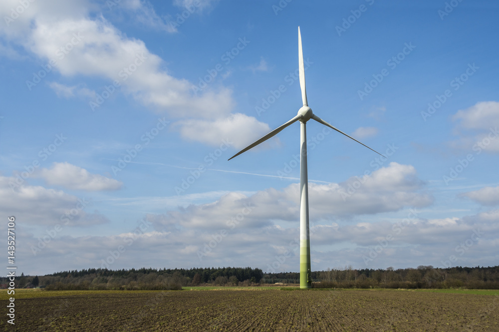 Wind turbines in landscape against blue sky Wind turbines in landscape against blue sky