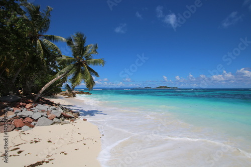 Beach Grand Anse, Anse Kerlan, Praslin Island, Seychelles, Indian Ocean, Africa / The beautiful white sandy beach is bordered by large red granite rocks.