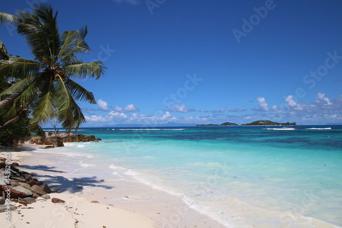 Beach Grand Anse, Anse Kerlan, Praslin Island, Seychelles, Indian Ocean, Africa / The beautiful white sandy beach is bordered by large red granite rocks. © sarlay