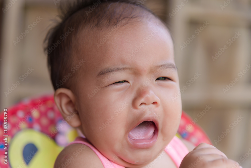 Cute asian baby toddler girl crying on red stroller. Cute asian baby toddler girl crying on red stroller.