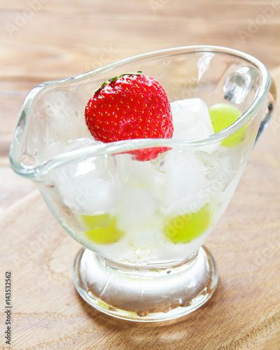 Wallpaper Mural Juicy strawberry in a glass container with ice on a wooden surface. Selective focus Torontodigital.ca