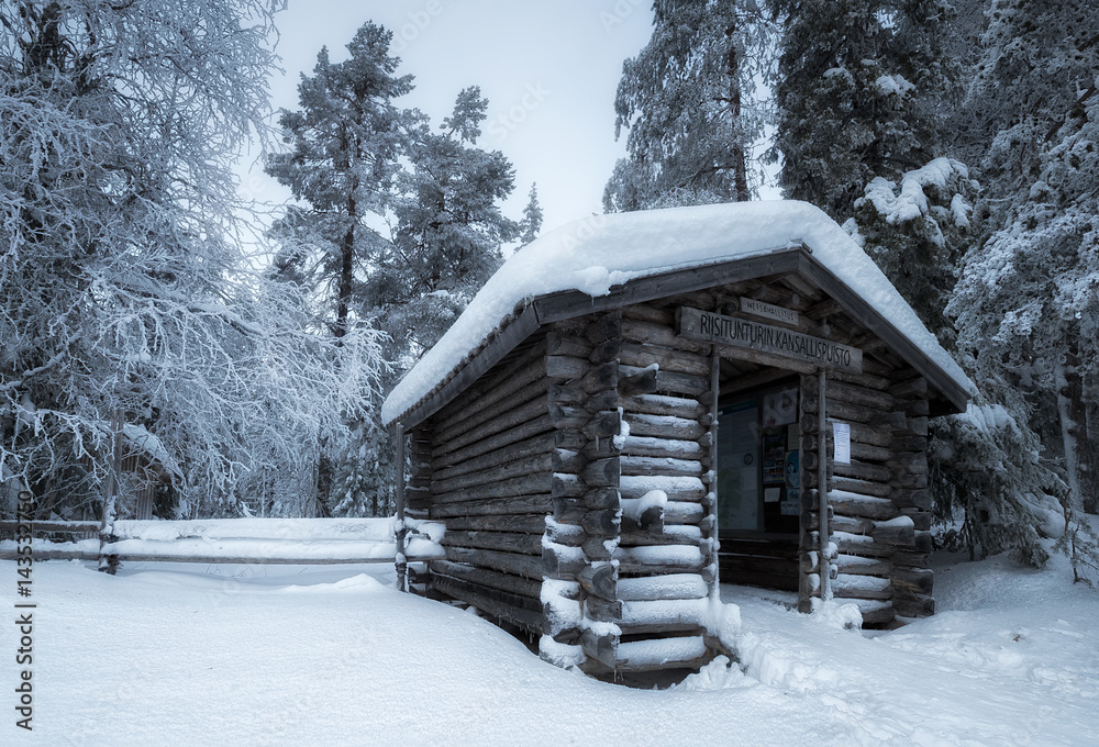 View of log cabin covered with snow at Riisitunturi National Park