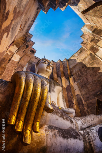 Seated Buddha image at  Wat Si Chum temple in Sukhothai Historical Park  a UNESCO world heritage site in Thailand