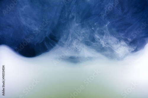 white and dark blue Ink spilled in water. abstract background