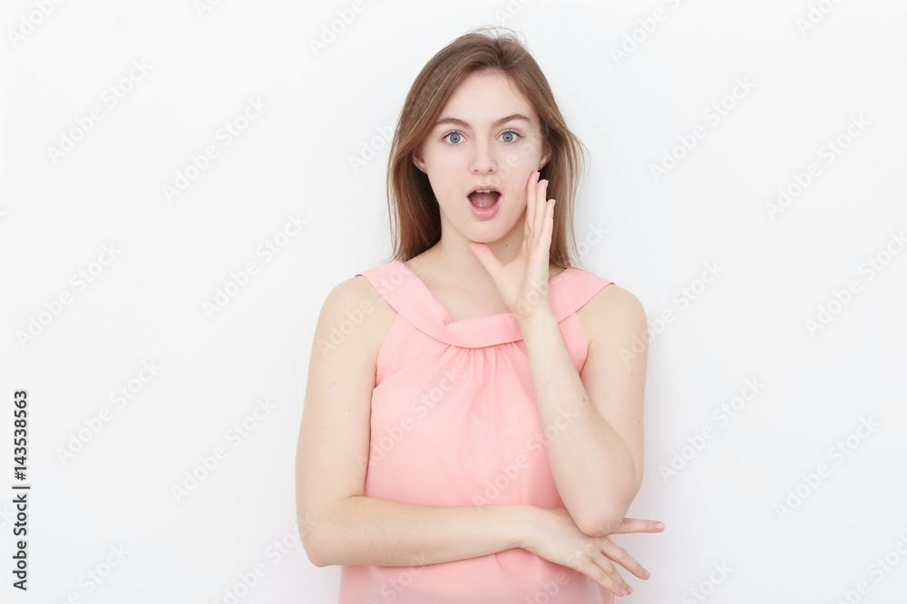 Young casual woman In pink blouse isolated over white background studio portrait Young casual woman In pink blouse isolated over white background studio portrait