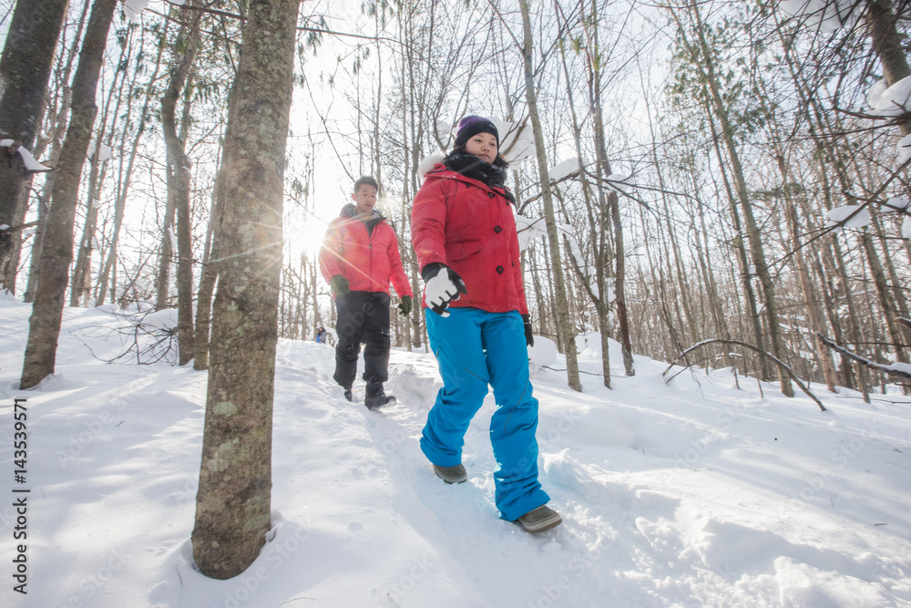 Asian couple hiking in the winter