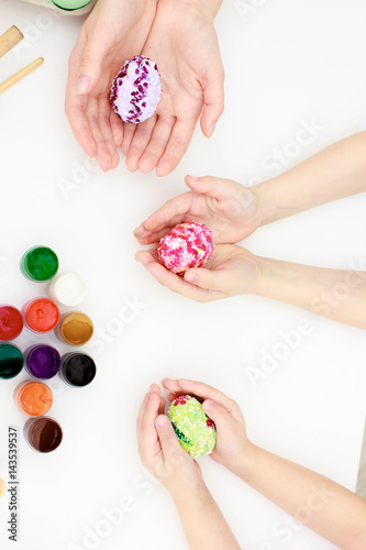 Happy easter, mother's and daughter's hands painting Easter eggs