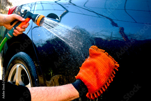 Car hand washing. A man washes his car.