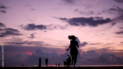Pretty Young Girl Running with her Dog at Beautiful Sunset on the Beach. HD Slowmotion. Phangan, Thailand.