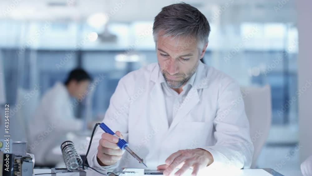 Portrait smiling electronics engineer working in the lab