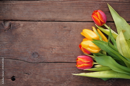 Fototapeta Naklejka Na Ścianę i Meble -  Tulips on wooden vintage background for Mother's Day .