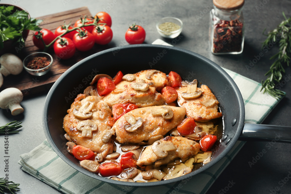 Frying pan with delicious chicken marsala on table Frying pan with delicious chicken marsala on table
