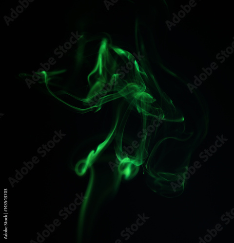 Swirl of green smoke on black background
