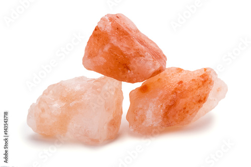 Closeup of Himalayan pink rock salt Isolated over white background photo