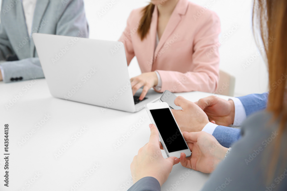 Team work concept. People sitting at table in office and using digital devices Team work concept. People sitting at table in office and using digital devices
