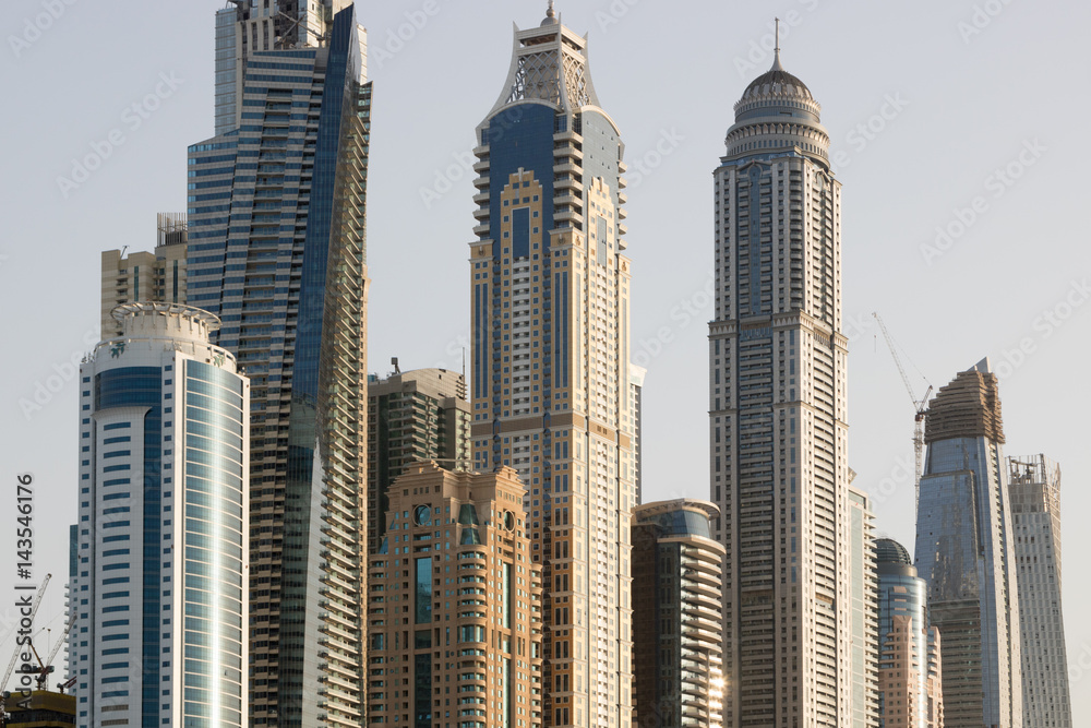 Naklejka premium Dubai Marina tall skyscrapers in a bright warm evening