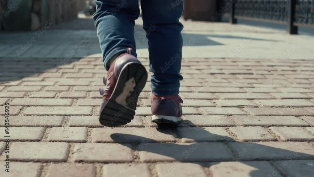 Child Girl Toddler Legs In Jeans On Street Pavement During Family Walking Child Girl Toddler Legs In Jeans On Street Pavement During Family Walking