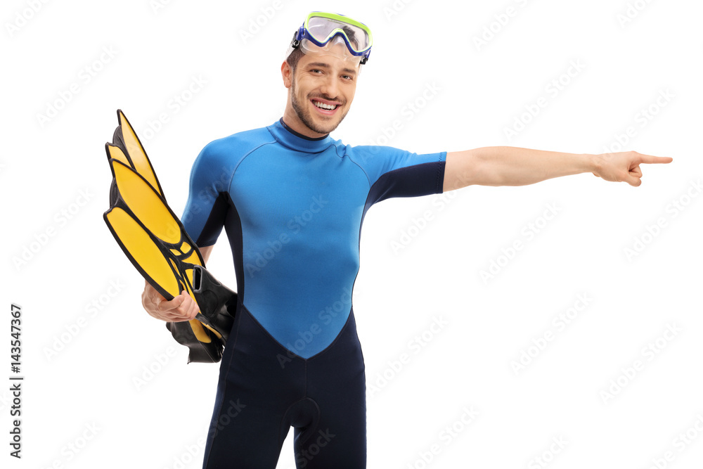 Guy in a wetsuit with snorkeling equipment pointing right Guy in a wetsuit with snorkeling equipment pointing right