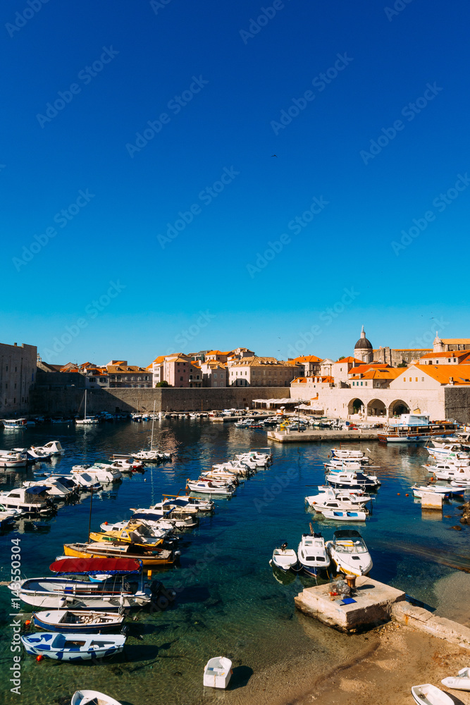 The boat dock near the old city of Dubrovnik, Croatia. The harbor, a marina, near the ancient city.