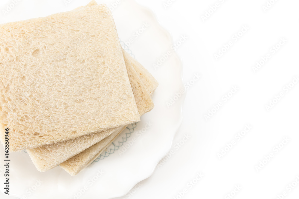 White sandwich bread slices on plate, on white background.