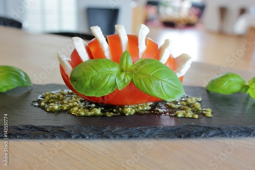 Traditional, italian caprese salad with tomato, mozzorella, pesto and basil photo