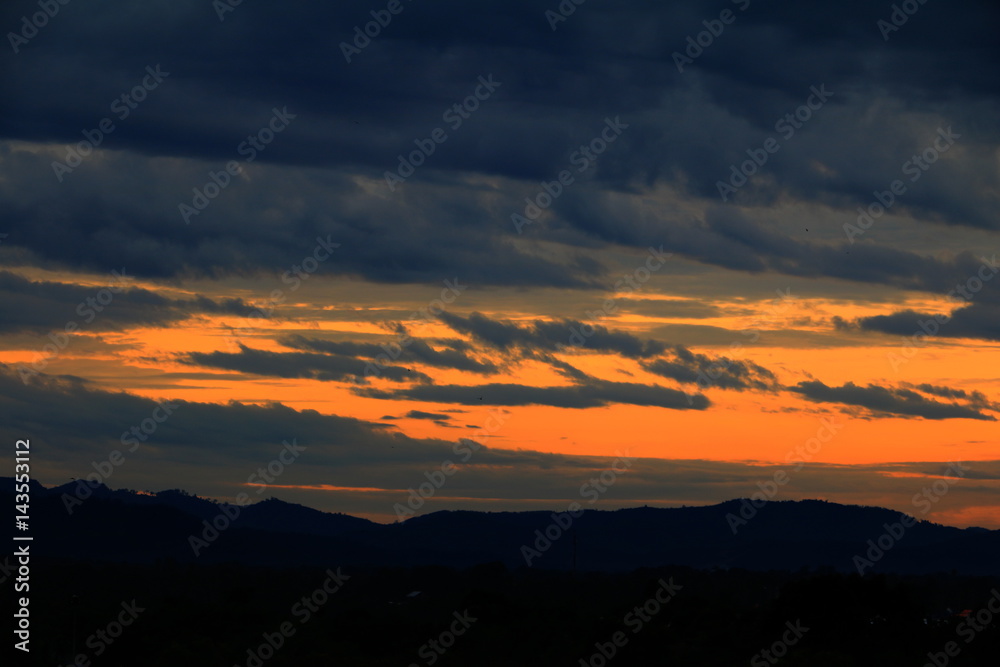 sunset in sky and rain cloud  beautiful colorful twilight time with mountain silhouette