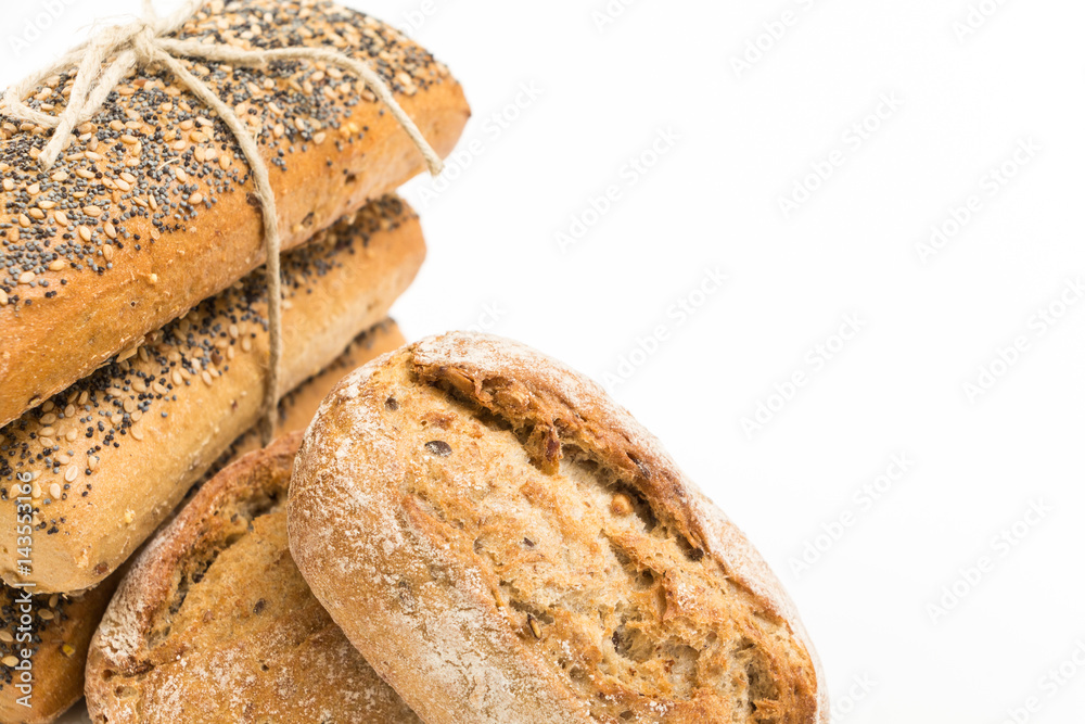 Whole wheat sandwich buns with seeds, on white background.