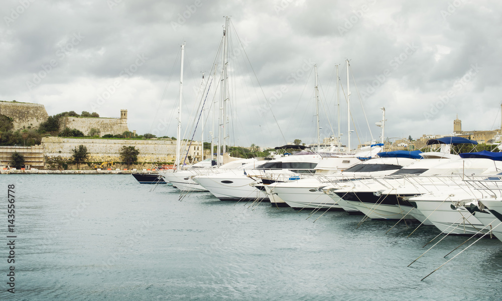 View of Valletta`s Fort St Elmo and yachts moored at Msida Marina, Malta