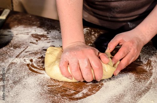 Kneading dough for bread baking. photo