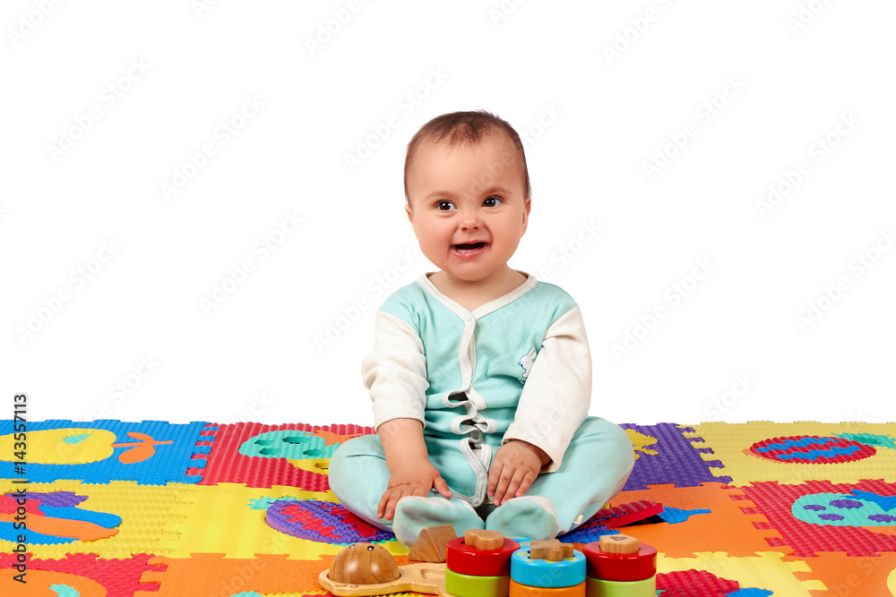 baby girl playing wooden toy blocks isolated on Soft mat baby girl playing wooden toy blocks isolated on Soft mat