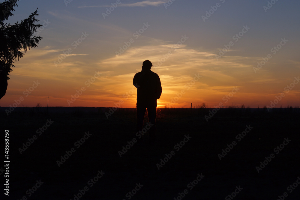 Pensive man in the rays of sunset
