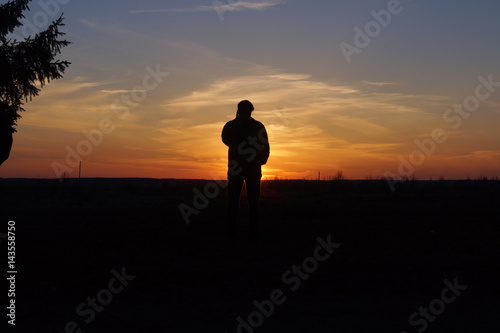 Pensive man in the rays of sunset