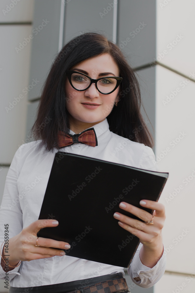 Modern business, woman near the office ponders business plan Modern business, woman near the office ponders business plan