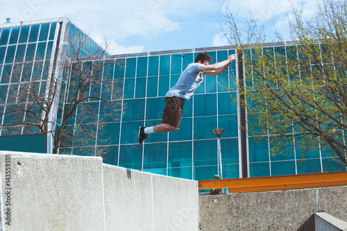young man doing parkour in the city