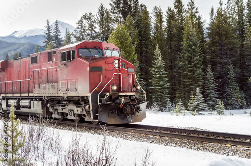 Locomotive in Motion through a Snowy Forest on a Winter Day