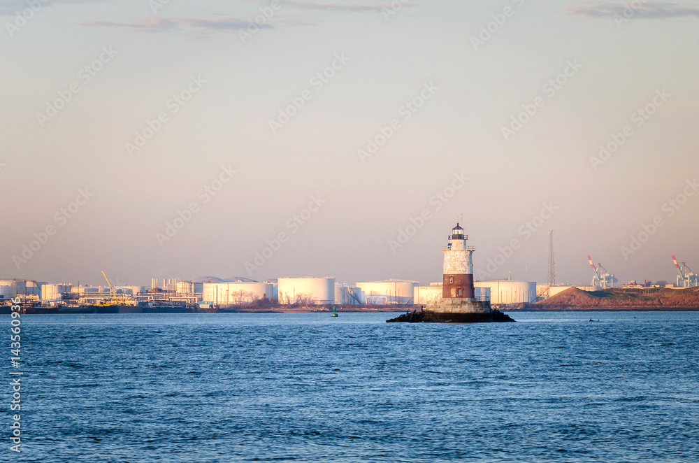 Robbins Reef Light in New York Bay at Dawn. Oil Tanks are visible in Background.
