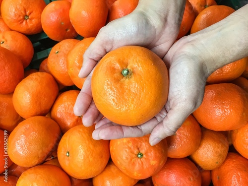 Choosing orange from the food counter