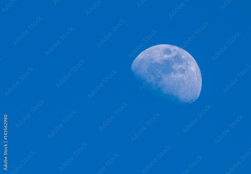 Early morning Moon in a Waxing Gibbous phase in the bright blue sky background. Detailed craters. Copy space. Early morning Moon in a Waxing Gibbous phase in the bright blue sky background. Detailed craters. Copy space.
