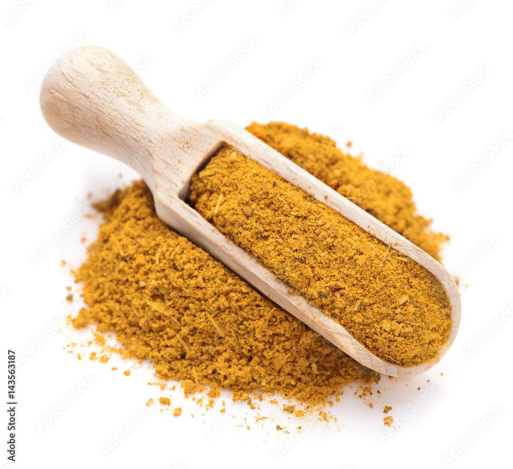 Curry spice in a scoop for spices Curry spice in a scoop for spices