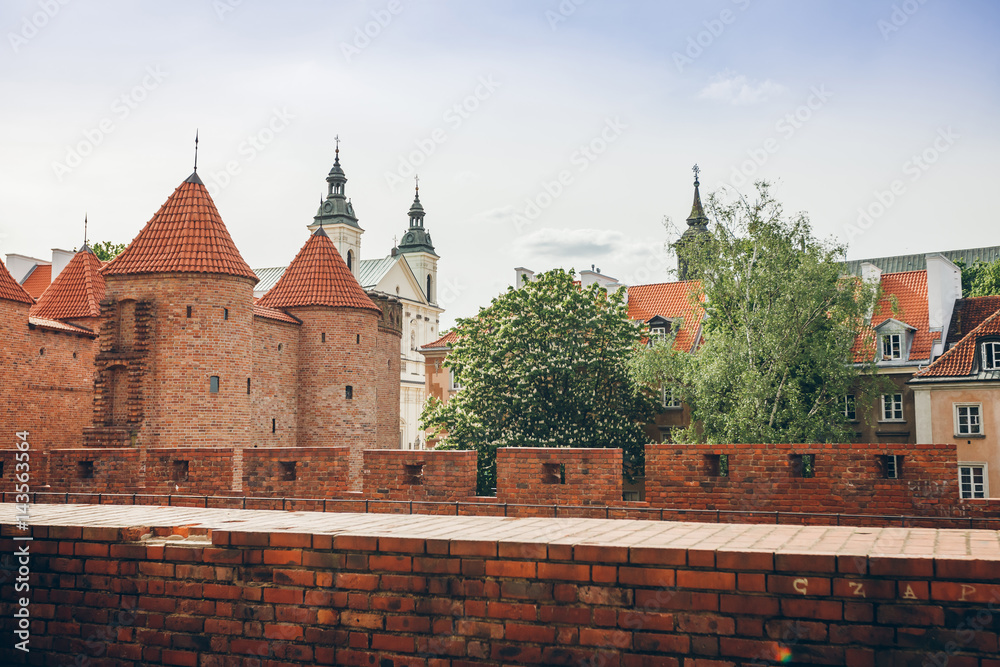 General view on Barbakan (Barbican) walls in historic center of Warsaw in Poland. Fortified medieval outpost .Summer time.
