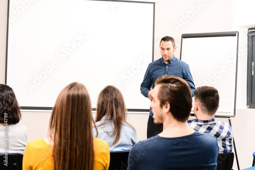 young business man manager on meeting in a conference room speaking in front of company staff or students